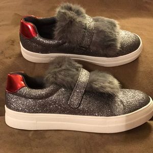 Silver glitter sneakers with faux fur tongue.